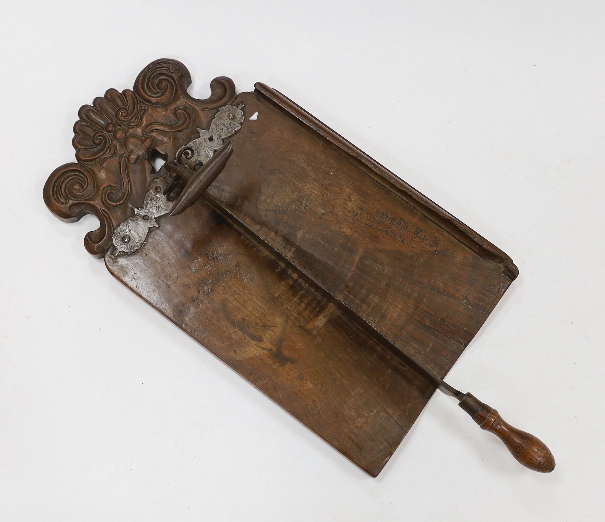 An 18th century Italian carved mahogany bread cutter, mounted wrought and cast iron hinged knife, 80cm high